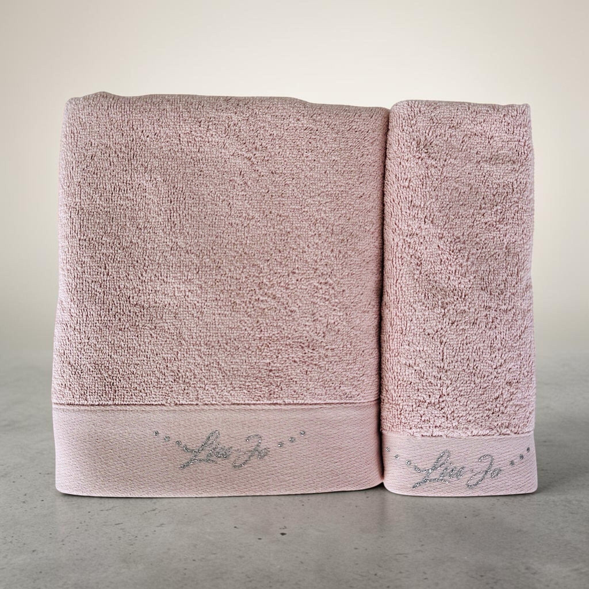 Asciugamano viso e ospite Liu Jo Happy rosa con logo in lurex argento su fondo neutro