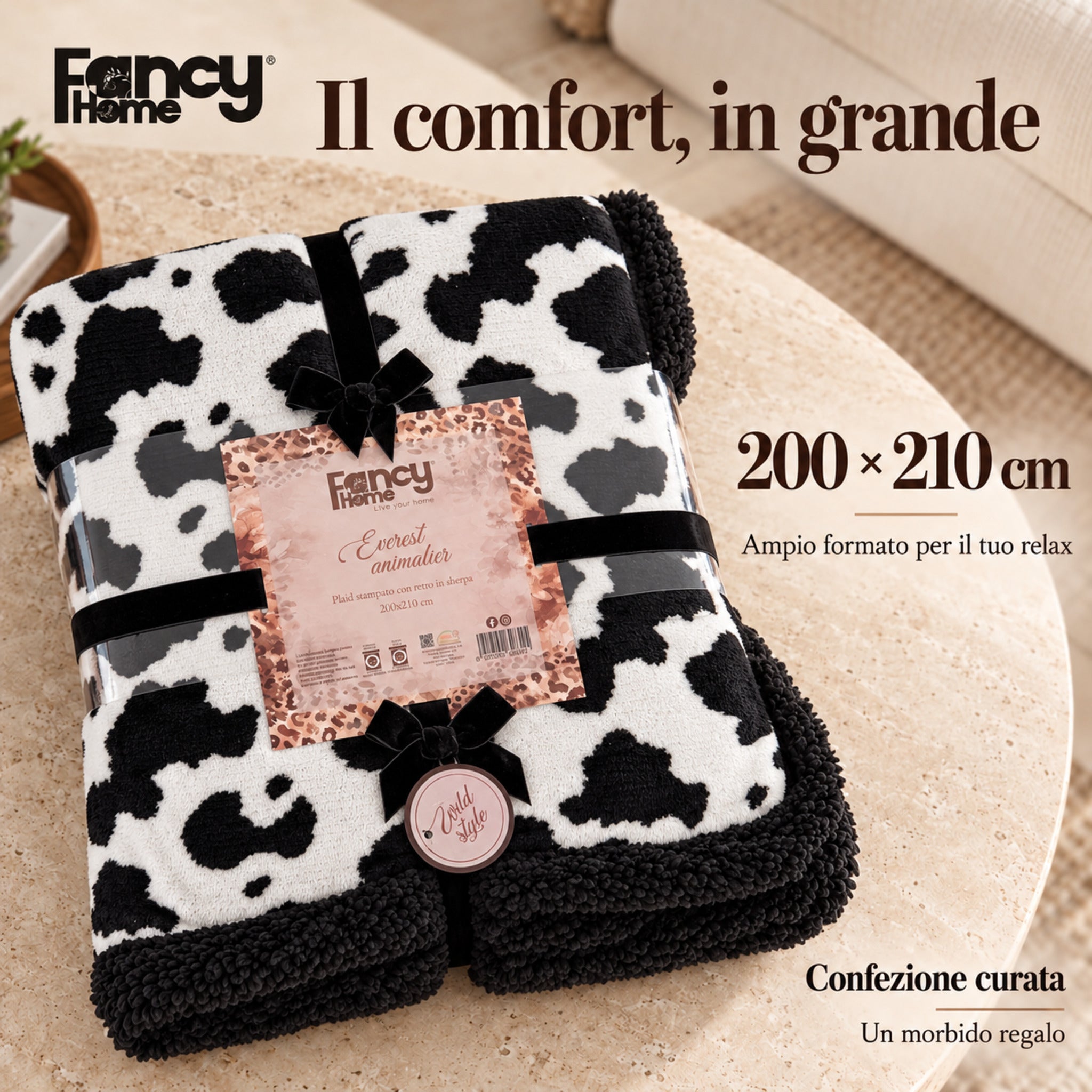 Plaid Everest maculato bianco e nero confezionato con fiocchi neri, etichetta Fancy Home e misura 200×210 cm.